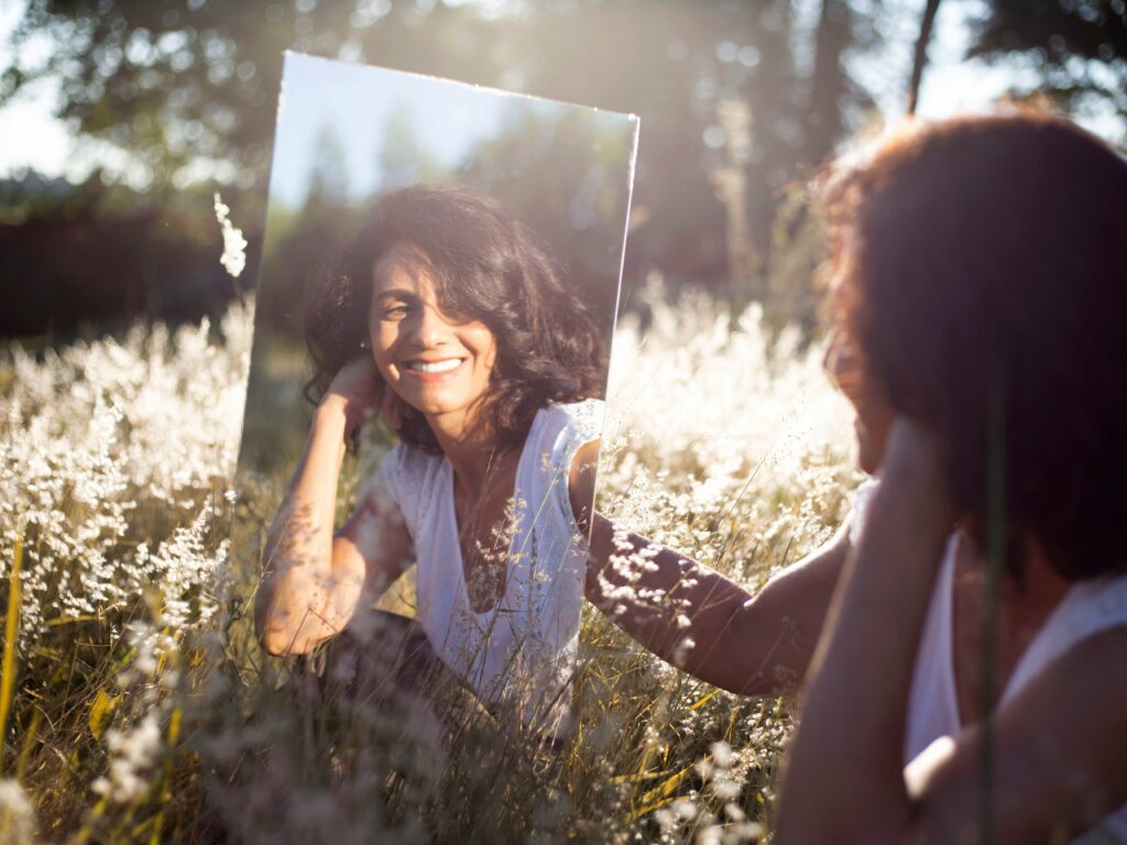 Person in relaxed clothing enjoying a peaceful moment outdoors, symbolizing body acceptance and ease.
